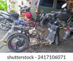 Small photo of Lamongan, Indonesia - January 25, 2024 : black Honda Vario motorbike engine dismantling workshop The condition of the Honda motorbike has been dismantled and ready to be serviced