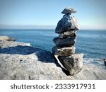 Small photo of Stacked stones set on the sea shore. A bit of a tongue twister, isn't it? This is captured on the pacific coast of the US.