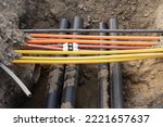 Small photo of connecting underground cable infrastructure improvement installation. Construction site with A lot of communication Cables protected in tubes. high speed Internet Network cables are buried
