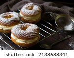 Custard rings with cheese wipped cream -homemade baking background. Paris Brest custard cakes. Baking recipe layout