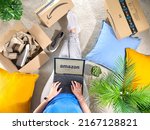 Small photo of Germany, Rostock - Juni 13, 2021: Stack of Amazon Prime packages. Woman shopping online on Amazon Prime Day. Distance, home, and online shopping