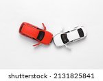 Small photo of Two mini toy car crash on white background, incident, car traffic accident. Top view