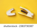 Small photo of Stapler and anti-stapler on a yellow background