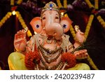 Small photo of Ganesh is the elephant-headed god who is the son of Shiva (the destroyer) and Parvathi (his consort), made from clay. Ganesh's body is representative of Maya, or the physical, while his elephant head