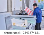 Small photo of Istanbul Turkey- July 11, 2023: people working in a sticker printing factory. worker uses a stickier printing machine. sticker printer.