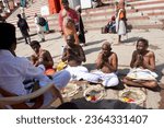 Small photo of Varanasi, Uttar Pradesh India - June 21, 2023: couple of Indian monks. sitting on the street. monks in their traditional clothes. Indian monks praying