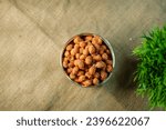Roasted masala coated crunchy and spicy masala peanuts or mungfali served in a bowl , Peanut ,groundnut, oil nut, monkey nut good for cardiovascular health.Traditional kerala snack, Kerala snacks