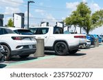Small photo of Austin , Texas , USA - September 5th 2023: Electrify America Charging Stations full of Electric Cars and the Rivian Electric Truck