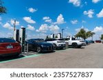 Small photo of Austin , Texas , USA - September 5th 2023: Electrify America Charging Stations full of Electric Cars and Electric Trucks charging up on Holiday