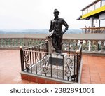 Small photo of Guatape, Antioquia, Colombia; October 25, 2023: Statue of Luis Eduardo Villegas. The first man to climb to the top of The Penol Stone in Guatape.