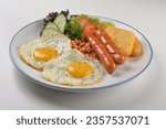 Small photo of America big breakfast with hash brown, fried scramble egg, sausage, grill bacon, ham, omelette, bean and green vegan salad in plate on white table asian cuisine halal food restaurant menu for cafe