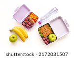 Healthy lunch boxes filled with fruits and vegetables, top view