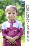 Small photo of a cute boy is posing while smiling, isolated by green bokeh background. on Last Saturday 22 April 2023 at Kuningan Indonesia.