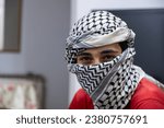 Small photo of portrait of person wearing white keffiyeh on lightened background with anger expression on his eyes due to violence and against occupation