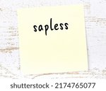 Small photo of Concept of reminder about sapless. Yellow sticky sheet of paper on wooden wall with inscription