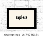 Small photo of Black wooden frame with inscription sapless hanging on white brick wall