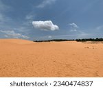 Red sand dune is the famous sight-seeing in Mui Ne, Vietnam. Red sand desert with blue sky view. Beautiful desert scenery in Mui Ne, Vietnam. Nice sunny desert view. Red sand landscape