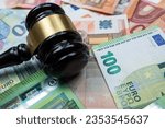 Small photo of Judge hammer above euro banknotes money. Bribe concept. The law or legel idea