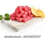 Small photo of Artisanal Tuna Sensation. Cubes of Fresh Tuna Arranged on a Polished Cutting Board, Accentuated with Zesty Lemon and Fragrant Parsley, Inviting the Palate to Revel in the Sublime Culinary Craftsmansh