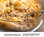 Small photo of cheesy beef and hash brown-casserole-Crispy but tender shredded potatoes top a casserole of juicy ground beef bound together with a ..