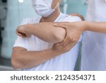 Small photo of Physiotherapist is doing physical therapy for a patient, the patient has body aches due to overwork and has undergone treatment and physiotherapy with a professional physiotherapist.
