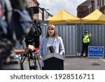 Small photo of Salisbury, UK - July 6, 2018: A news reporter broadcasts live on TV as police cordon off a hostel as investigations continue after local residents fall ill with nerve agent poisoning.