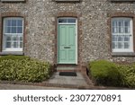 Small photo of Exterior view of a beautiful old flint stone house on a street in an English town
