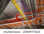 Wiring and cabling in large building. Pipes and cable trays. Building infrastructure and control systems