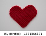 Red Knitted Heart On A White...
