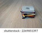 Small photo of vintage retro electronic data storage devices, from the 80s, 90s flash drives scattered on the table. Stack of floppy disks, pendrive and hard disk in grey, black, blue, yellow, red, white