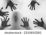 Small photo of eerie blurry hands and face of people as if they have been trapped behind glass, dense fabric, wrap, ghost, spirit trying to reach out from afterlife, concept of violence, nightmares, halloween horror