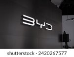 Small photo of glowing Advertising banners BYD on black background, Chinese conglomerate manufacturer BYD Auto, corporation logo sign, company brand logotype signboard in office, Frankfurt - January 31, 2024