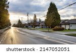 Small photo of Fraser Heights, Surrey, Greater Vancouver, BC, Canada. Street view in the Residential Neighborhood during a colorful spring season. Colorful Sunrise Sky.