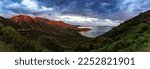 Small photo of Small Town on a Rocky Sea Coast. Porto Sa Ruxi, Sardinia, Italy. Dramatic Sunset Sky. Panorama