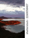 Small photo of Small Town on a Rocky Sea Coast. Porto Sa Ruxi, Sardinia, Italy. Dramatic Sunset Sky.