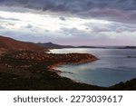 Small photo of Small Town on a Rocky Sea Coast. Porto Sa Ruxi, Sardinia, Italy. Dramatic Sunset Sky.