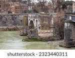 Small photo of ROME, ITALY - MARTH 10, 2023: This is the only surviving span of the stone ancient Roman Emilio Bridge over the Tiber River (2nd century BC).