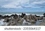 Small photo of Sea surf that expands in the air during. Sea driven by the fresh Mistral wind. Freedom of nature. Ancient rocks that on the coast embrace the impetuous sea that breaks furiously