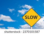 Yellow Slow Sign with Cloudy Sky in the background
