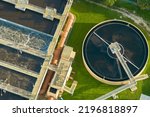 Small photo of Aerial view of modern water cleaning facility at urban wastewater treatment plant. Purification process of removing undesirable chemicals, suspended solids and gases from contaminated liquid