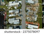 Property damage from strong hurricane winds. Mobile homes in Florida residential area with destroyed rooftops. Consequences of natural disaster