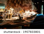 The served table in the luxury restaurant. Dark wooden table, beautiful evening restaurant with luxury rustic decor