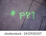 Small photo of PP with dot and question mark in green on new york streets