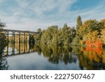 Small photo of Railway Bridge with river in Bietigheim-Bissingen, Germany. Autumn. Railway viaduct over the Enz River, built in 1853 by Karl von Etzel on a sunny summer day. Bietigheim-Bissingen, Germany. Old