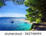 Beautiful beach Zlatni Rat or Golden Cape on island Brac in Croatia with yacht