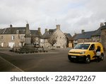Small photo of A view of the post lady delivering her parcels in Saint-Cyr-du-Bailleul, Manche, Normandy, France, Europe on Thursday, 30th, March, 2023