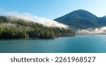 Small photo of Panorama landscape of islands with pine and cedar trees forest in mist along Inside Passage cruise between Prince Rupert and Port Hardy, Vancouver Island, British Columbia, Canada.