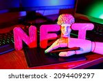NFT (Non-Fungible token). Artificial hand creates crypto art using a graphics tablet. Gypsum copy of ancient statue and the inscription NFT. Crypto art concept