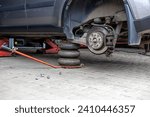 Small photo of Tyre service. Compressed air tool. Changing the tyres on the car, car service.Auto mechanic,in process of new tire replacement, Car brake repairing in garage.