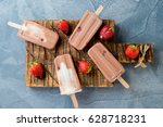 Homemade frozen ice cream chocolate popsicles with strawberry